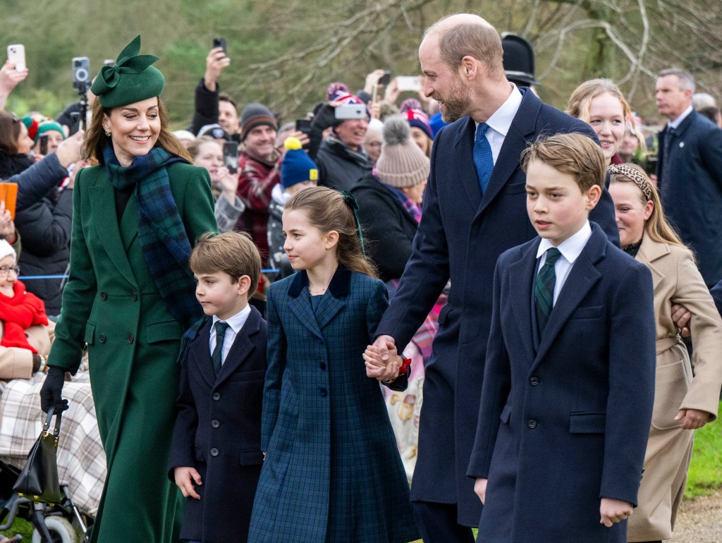 Kate Middleton and Prince William walking hand-in-hand with their three children
