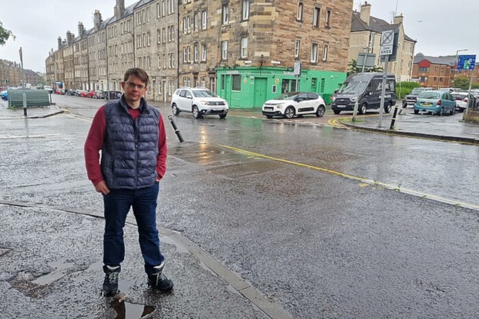 Councillor Jack Caldwell posing with the junction in question (C) Scottish Liberal Democrats / Jack Caldwell