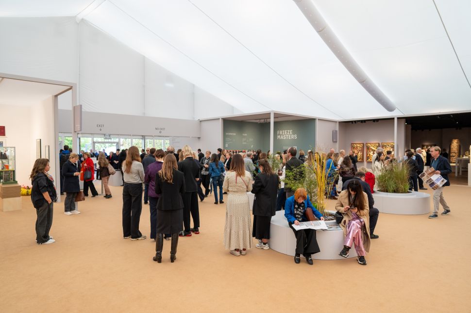 Fair crowd under a white tent. 