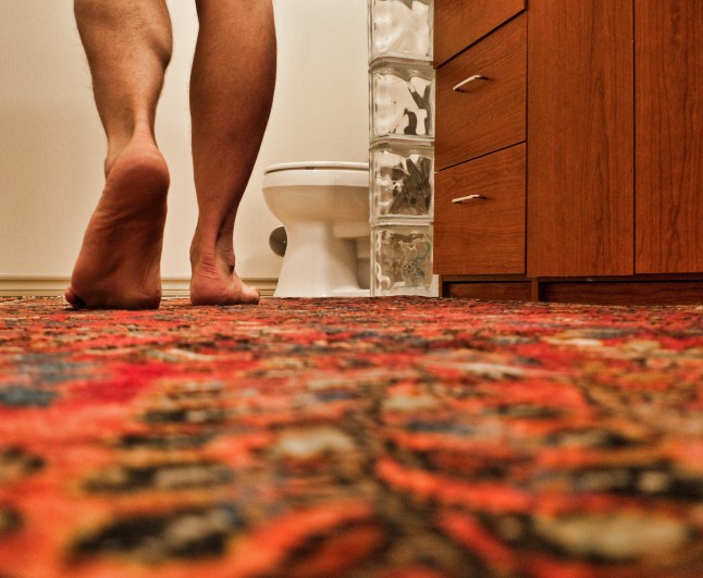 Low Angle View of Man Walking Toward Toilet