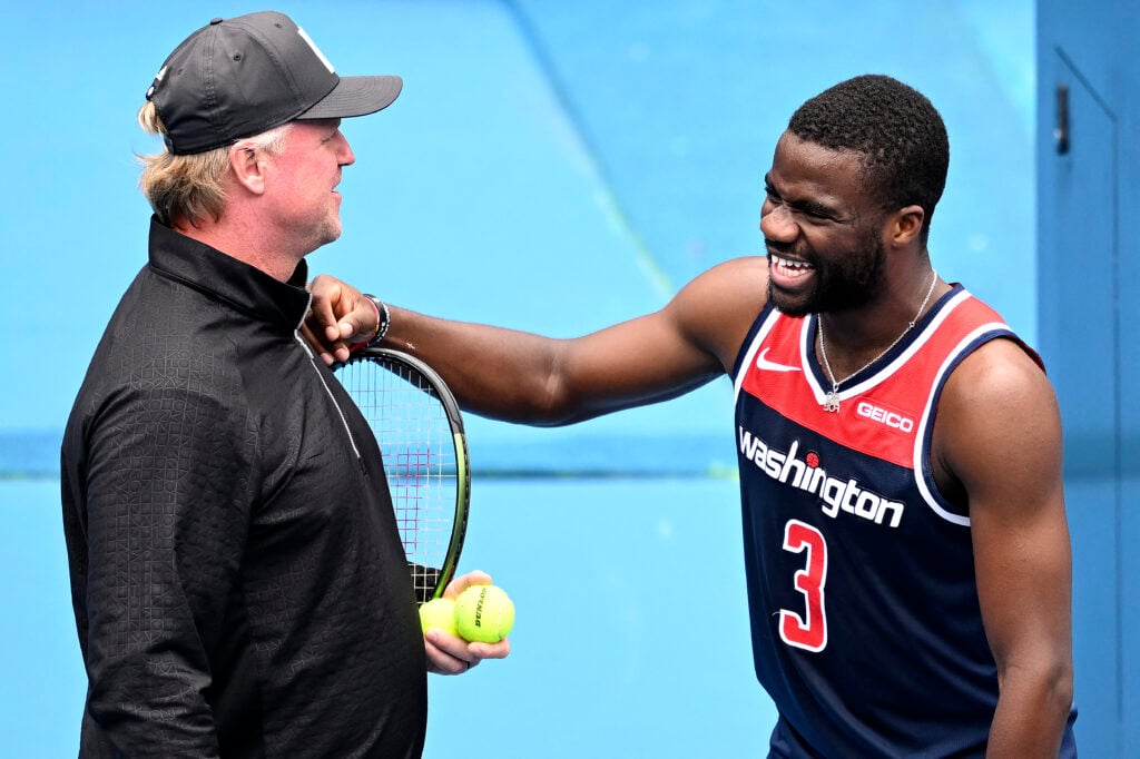 Frances Tiafoe of the US shares light moments with the coach David Witt during a practice session at the Malbourne Park ahead of the Australian Open tennis tournament in Melbourne.