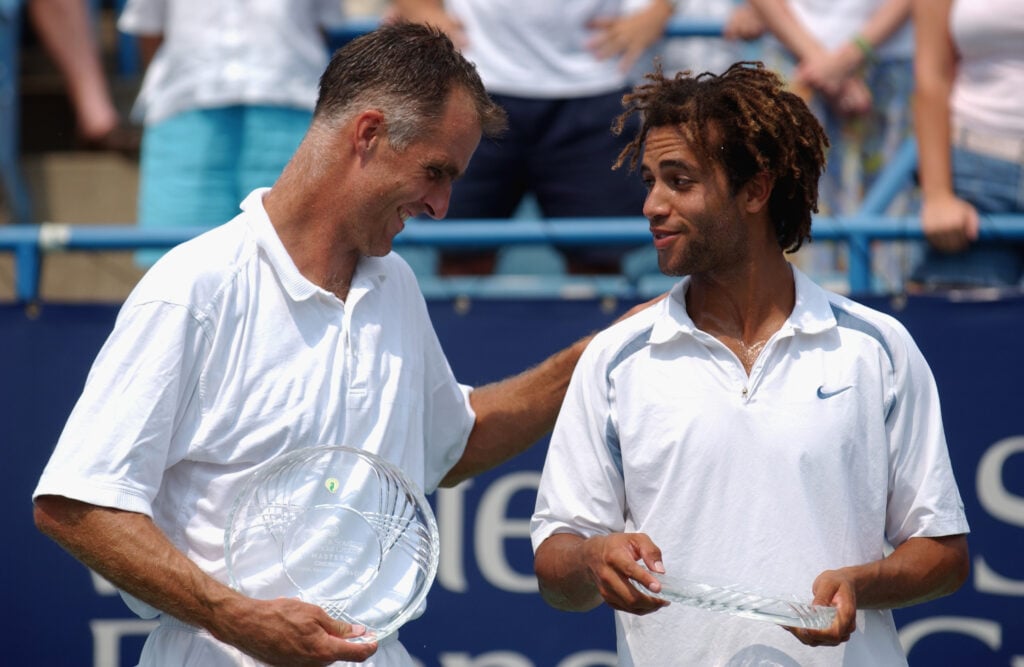 Todd Martin and James Blake pose for photographers after defeating Max Mirnyi and Mahesh Bhupathi during the Western & Southern Financial Group Masters.