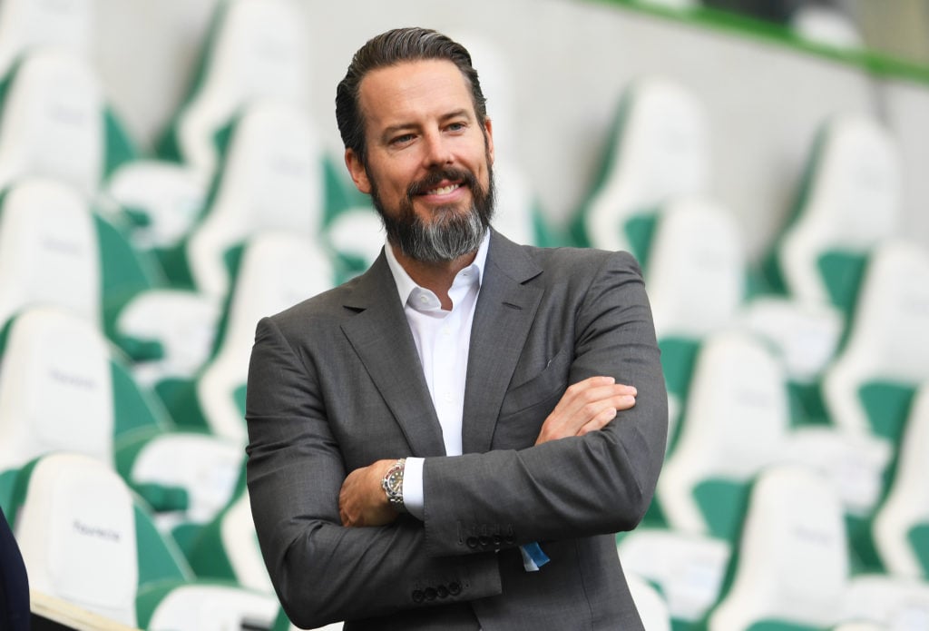 Josh Kroenke stands arms folded at an Arsenal Women's Champions League match