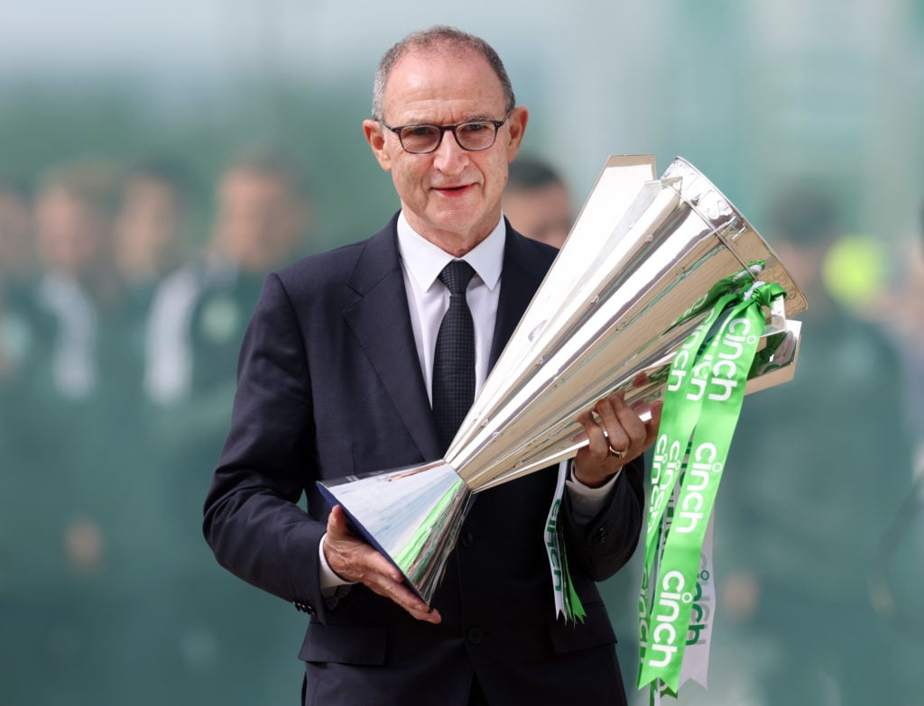 Martin O'Neill holding the Scottish Premiership trophy for Celtic against Aberdeen.