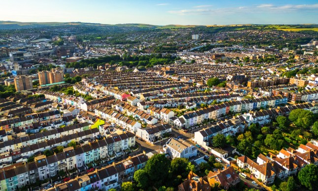 An aerial view of residential streets and houses in Brighton under a blue sky.