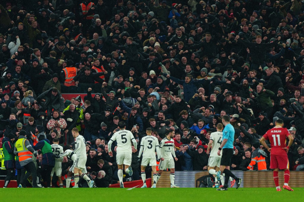 Lisandro Martinez of Manchester United celebrates in front of their fans in the Anfield Road End after scoring their first goal during the Premier League match between Liverpool and Manchester United at Anfield.