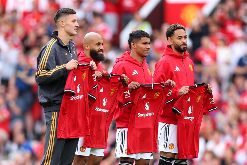 New signings Bryan Mbeumo, Benjamin Sesko, Diego Leon and Matheus Cunha pose for a photo while holding Manchester United shirts.