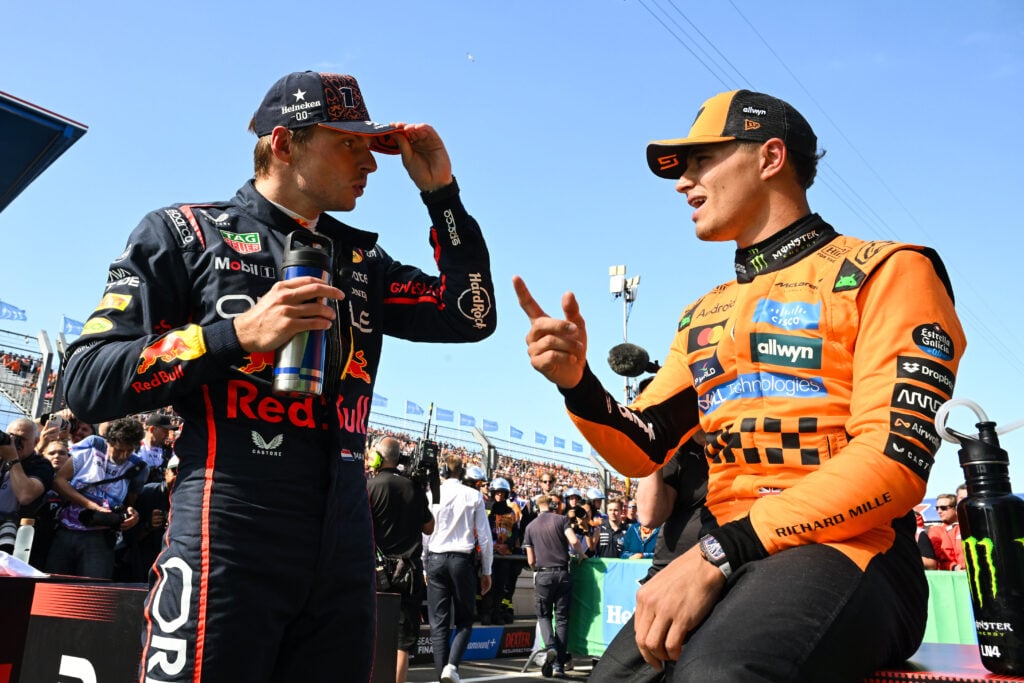 Lando Norris of McLaren talks to Max Verstappen of