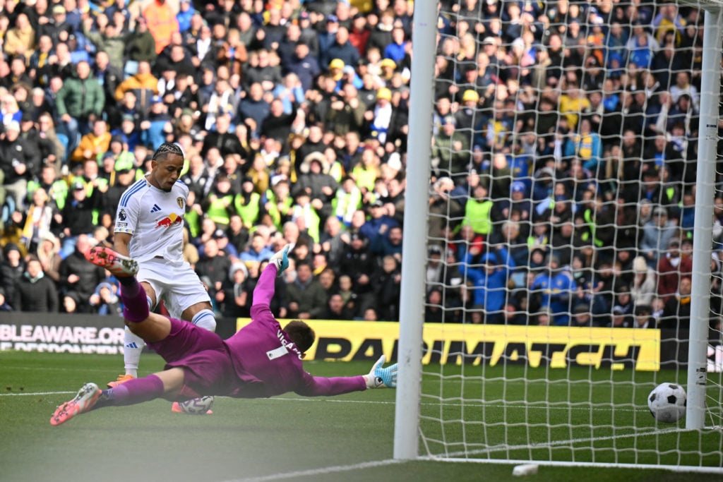 Leeds United forward Noah Okafor scores past Tottenham Hotspur goalkeeper Guglielmo Vicario.