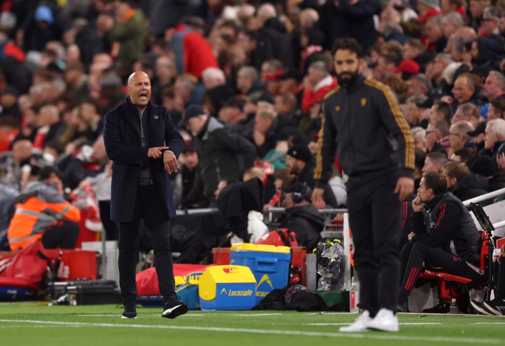 Arne Slot points to his watch vs Manchester United
