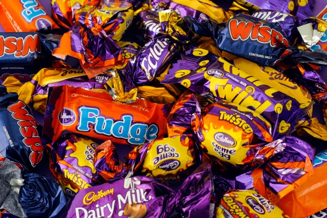 A pile of the bite-size chocolates from a box of Cadbury Heroes including Eclairs, Fudge, Dairy Milk and Twirls