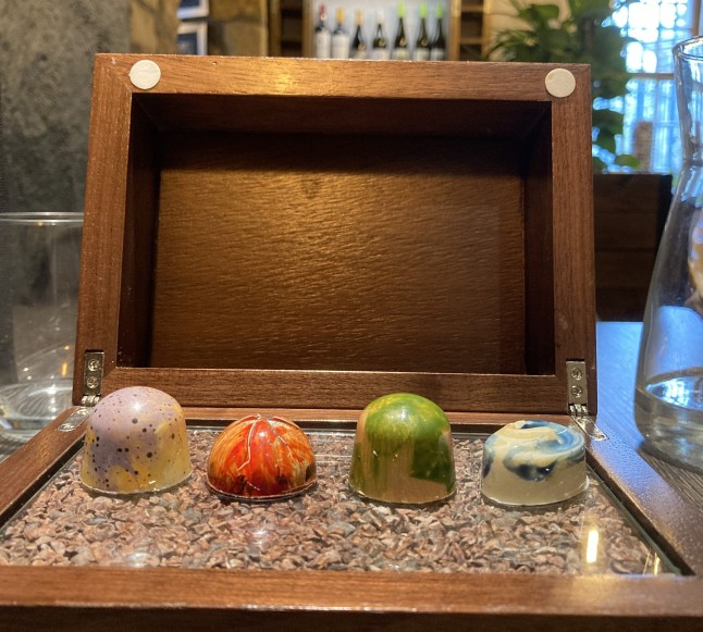A wooden box of artisan chocolates
