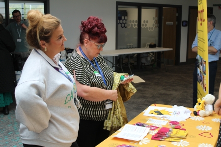 Two women standing at Bright Charity stall