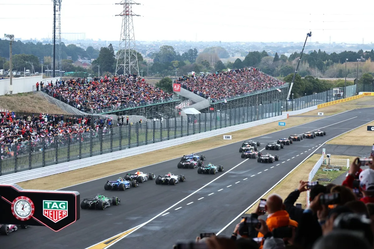 Formula 1 race cars pass stands packed with fans