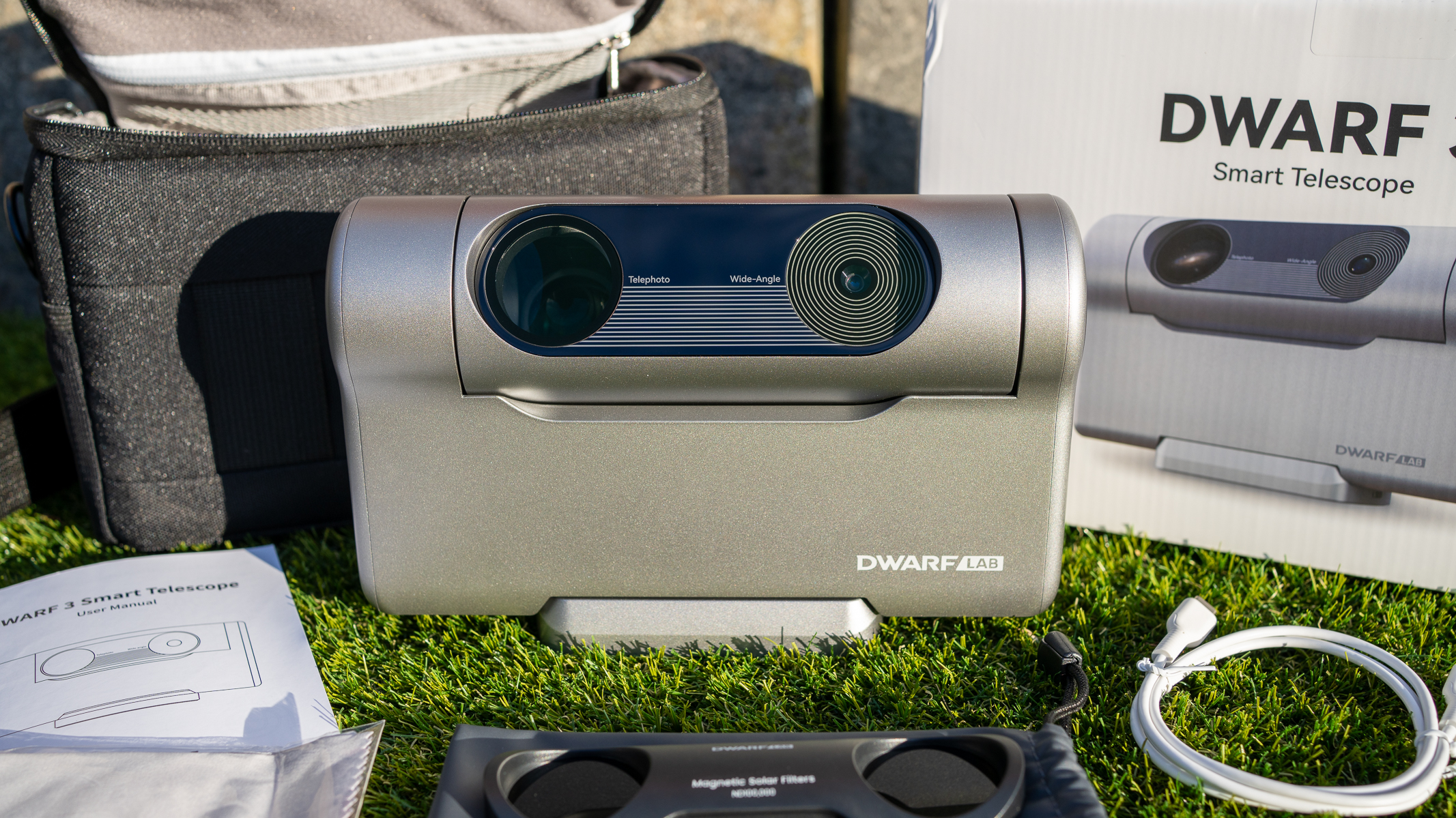 A close up of the DWARF 3 amongst other accessories on the grass.