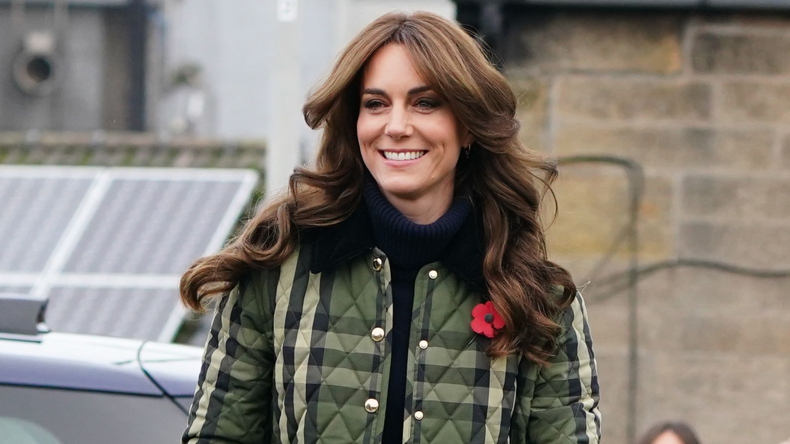 Catherine, Princess of Wales, wearing a quilted jacket, smiles as she visits Outfit Moray