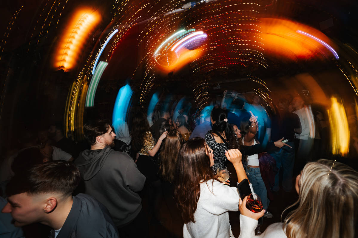 people dancing with lights spinning