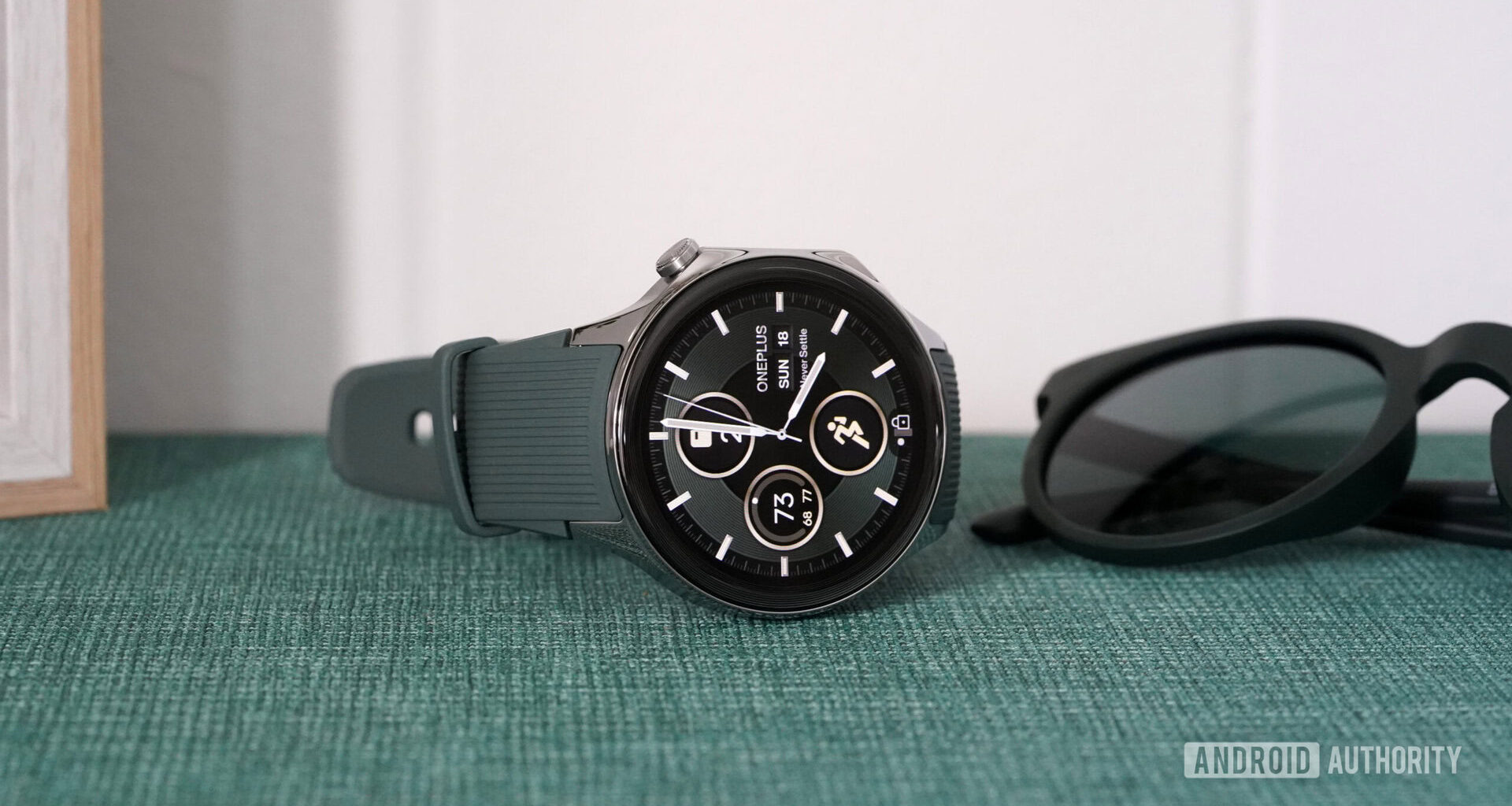 A OnePlus Watch 2 rests on its side displaying a native watch face.