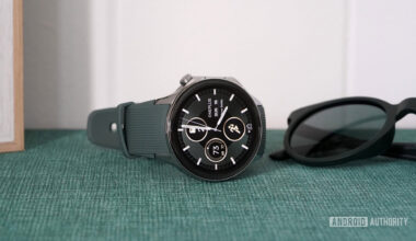 A OnePlus Watch 2 rests on its side displaying a native watch face.