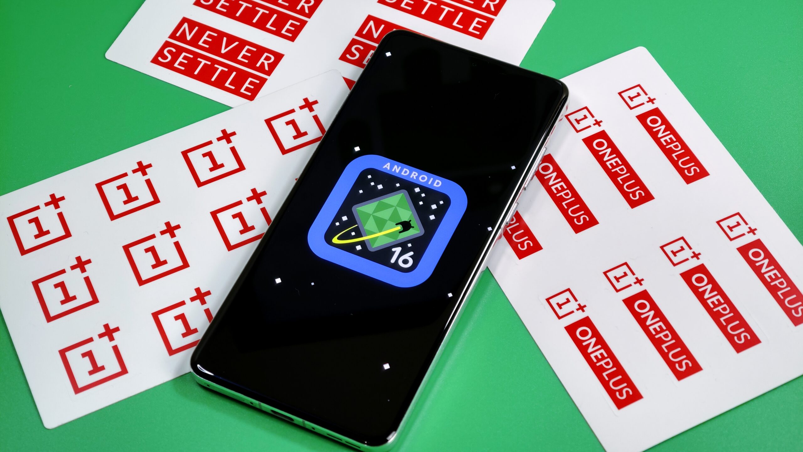 Photo of Android 16 logo on a OnePlus 13