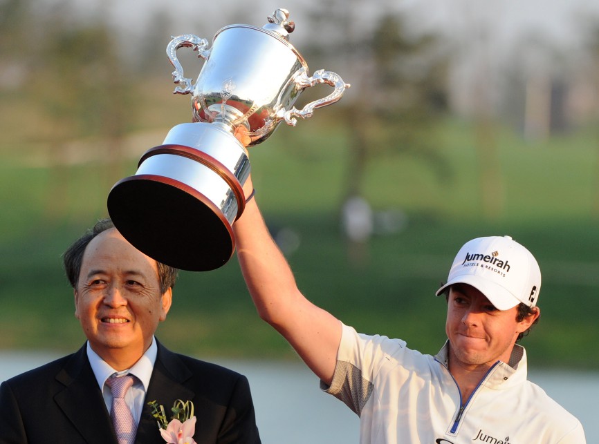 Rory McIlroy of Northern Ireland celebrates his USD$2 million win with the winners trophy after finishing at 18 under par on the final day of the Lake Malaren Shanghai Masters golf tournament in Shanghai on October 30, 2011. AFP PHOTO/Mark RALSTON (Photo credit should read MARK RALSTON/AFP/Getty Images)
