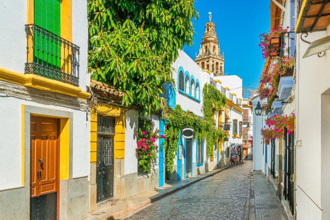 Scenic sight in the picturesque Cordoba jewish quarter with the bell tower of the Mosque Cathedral. Andalusia, Spain.