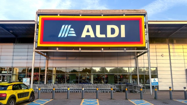 Shoppers enter a branch of the budget supermarket retailer Aldi in Weston-super-Mare, England