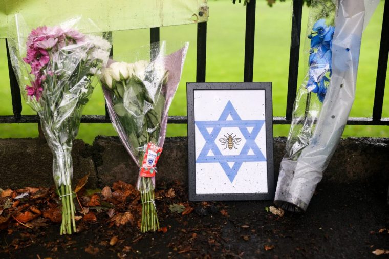 Flowers are left outside the Manchester synagogue, where multiple people were killed on Yom Kippur in what police have declared a terrorist incident, in north Manchester, Britain, October 3, 2025. REUTERS/Temilade Adelaja