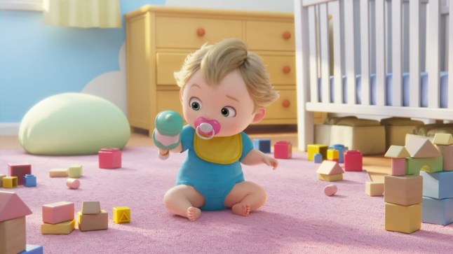 A baby sitting in a playroom holding a rattle from a mystery Nintendo trailer.