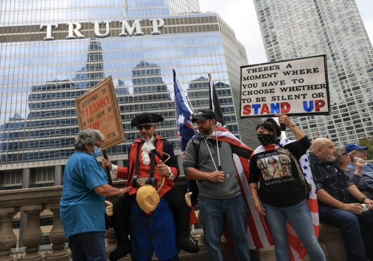 CHICAGO, ILLINOIS - OCTOBER 18: Protestors march past Trump International Hotel & Tower Chicago during the second