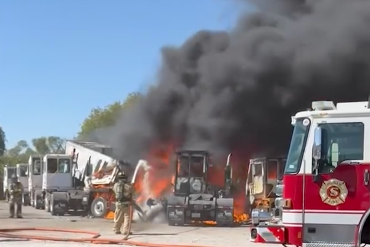 Two dead after plane crashes into trailers near Texas airfields as nearby building goes up in flames