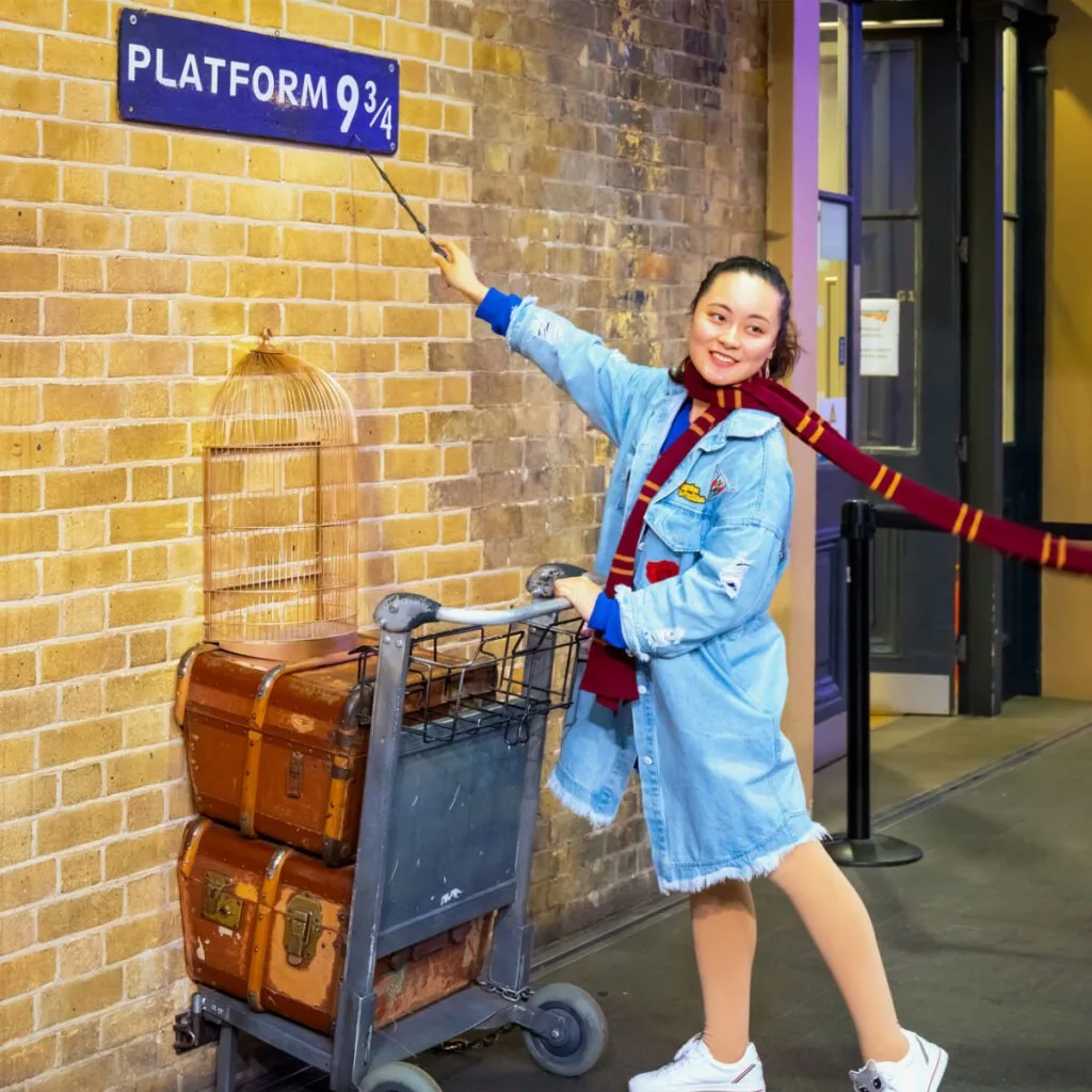 Traveler in Harry Potter attire at King's Cross in London