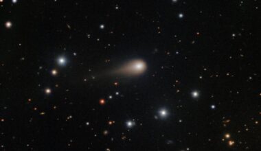 a photo of the comet 3I/ATLAS with its long tail shooting through space
