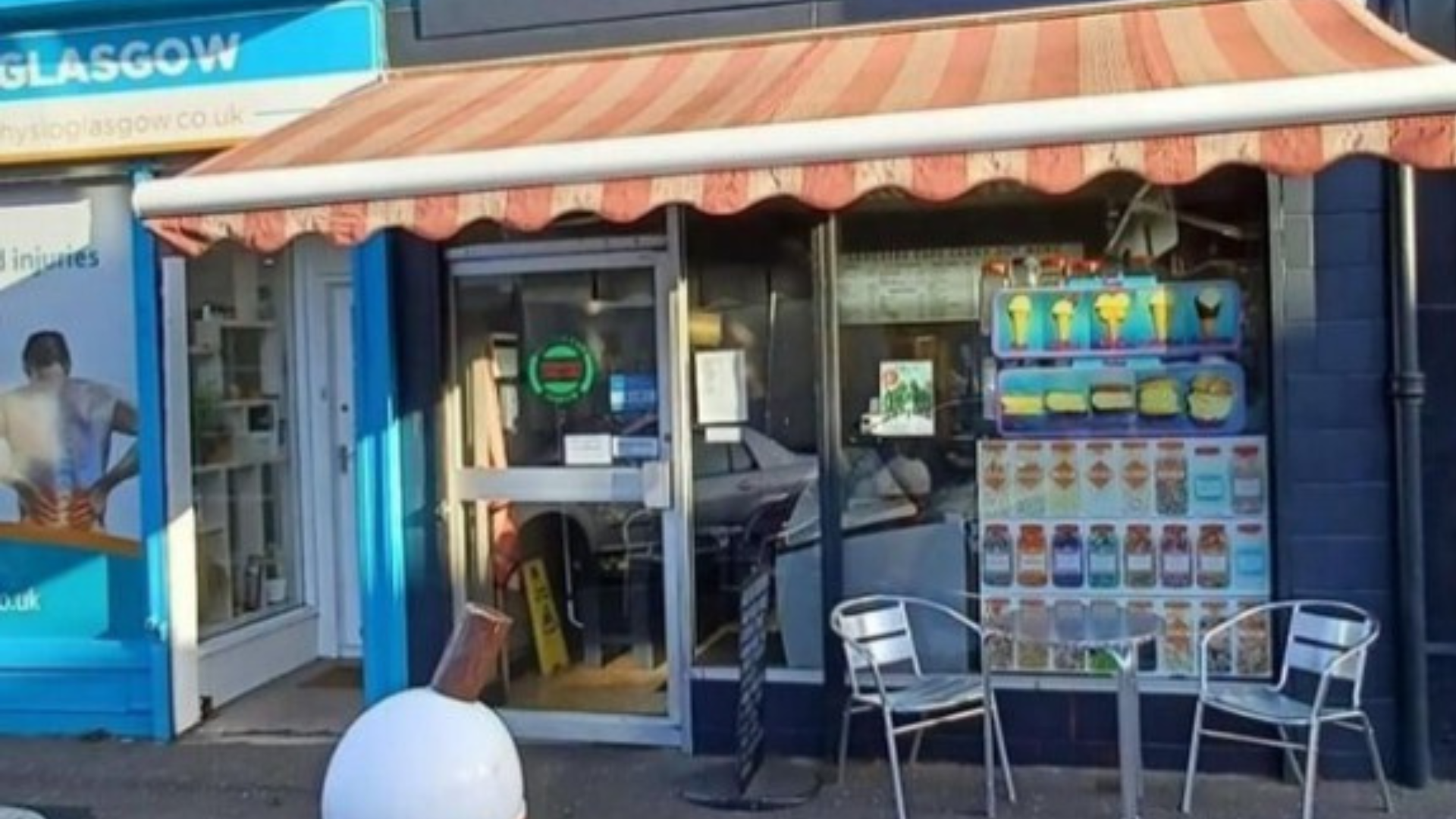 An ice cream parlor with outdoor seating next to a physical therapy clinic.
