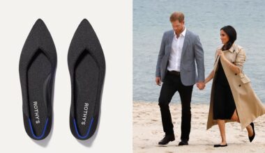 Meghan Markle holding hands with Prince Harry walking on a beach in a trench coat and black dress