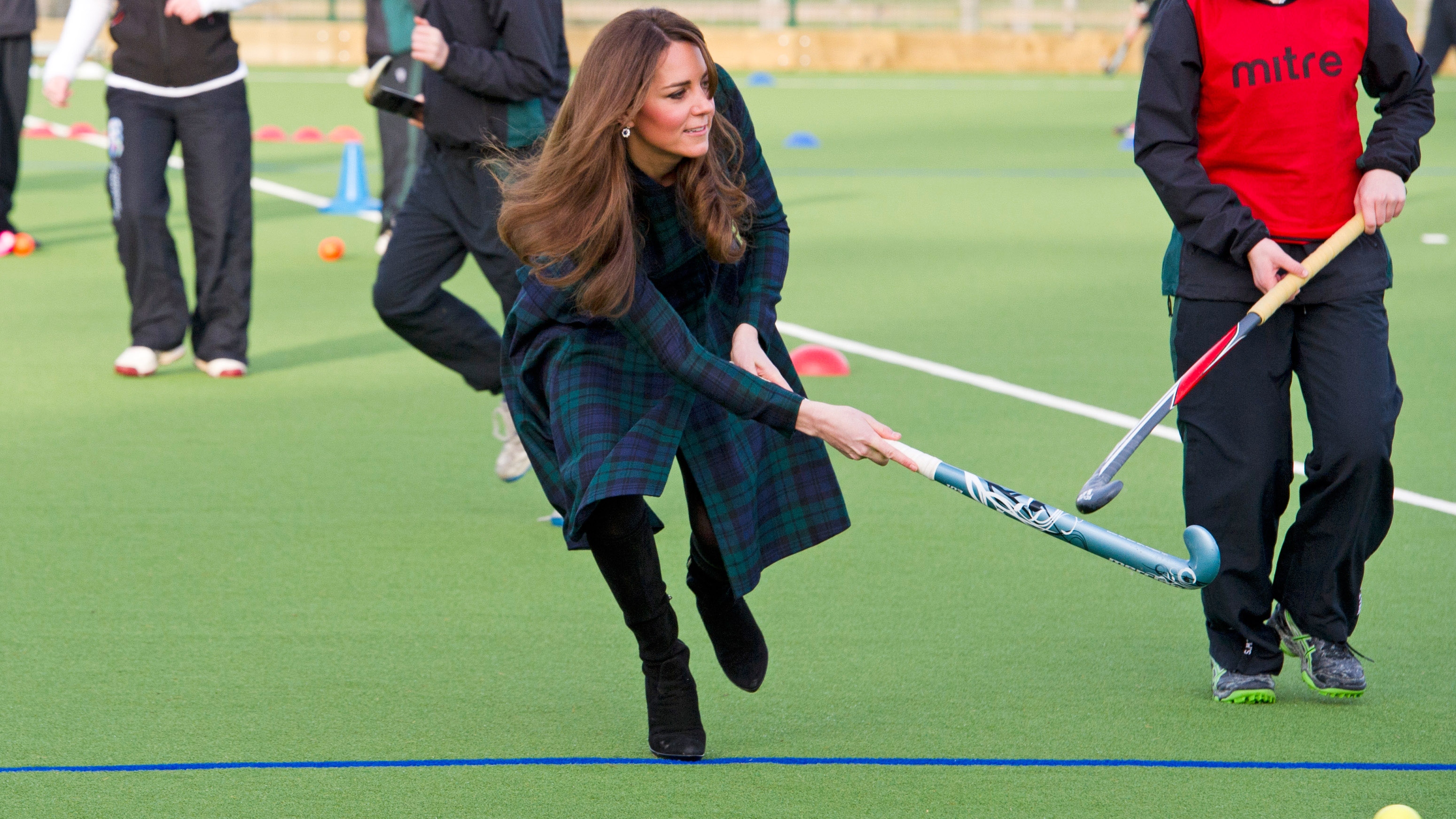 Kate Middleton takes part in a game of hockey at St Andrew's School on November 30, 2012