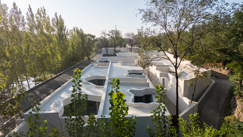 cluster of interwoven white courtyard houses reinterprets ancient kilns for resort in china