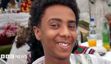 A young boy smiling at the camera.