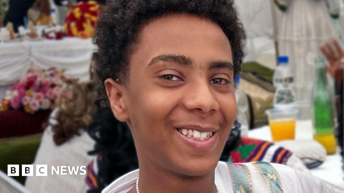 A young boy smiling at the camera.