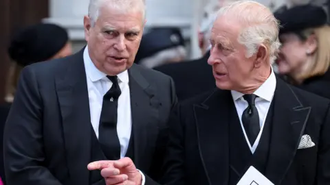 Reuters Prince Andrew and King Charles, dressed in black mourning clothes, at the funeral of the Duchess of Kent