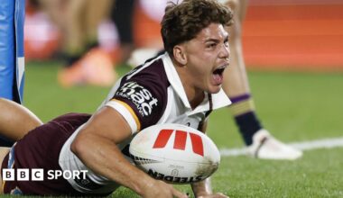 Brisbane Broncos full-back Reece Walsh with a medal around his neck