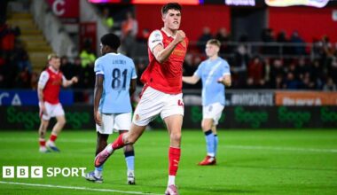 Josh Ayres celebrates with a clenched fist after scoring Rotherham's second goal against Manchester City
