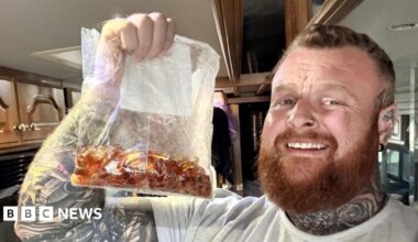 Nathan Rimmington holds up a bag of cola bottle sweets.