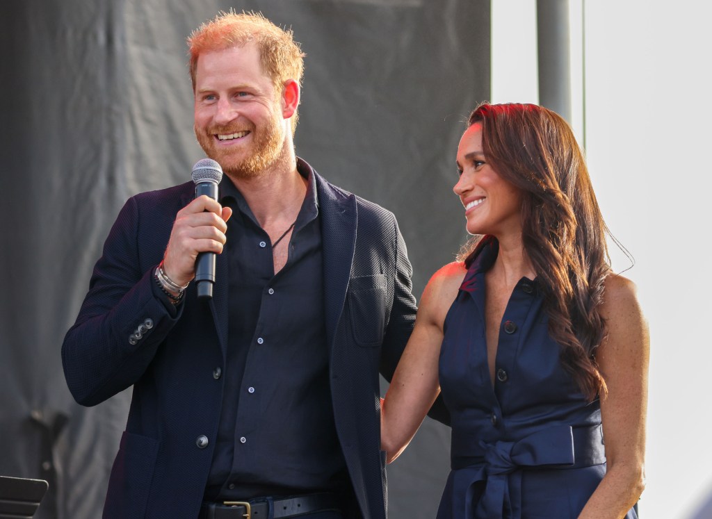 Prince Harry and Meghan Markle smiling at each other