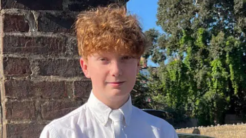 Family handout / PA Media A teenage boy with curly hair looks at the camera