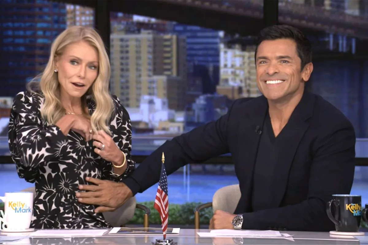 Mark Consuelos flirtatiously reaches for Kelly Ripa's mic that fell 'deep into the cleavage' on air: 'Can I find it?'