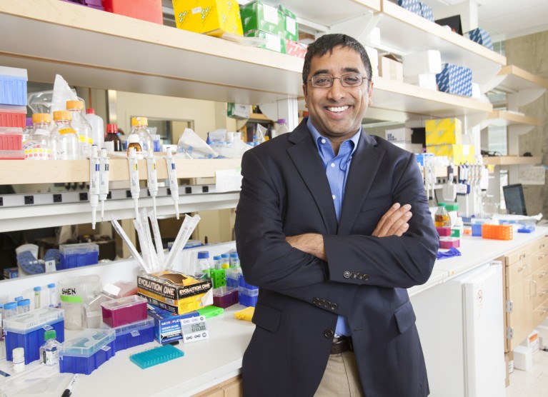 Jay Shendure standing in his lab with his arms crossed.