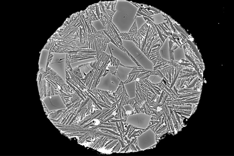 Microscope image of a meteorite fragment showing crystal-like shapes from a sample of the far side on the moon.