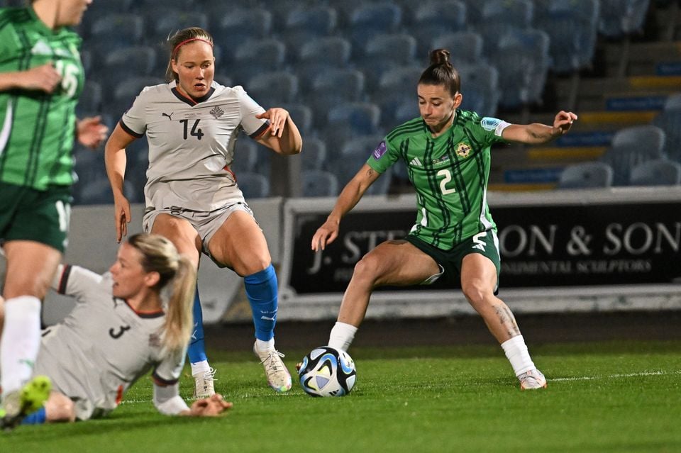 Northern Ireland defender Rebecca McKenna looks to control the ball under pressure from Iceland’s Hlín Eiríksdóttir