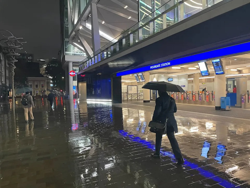A man walks past Moorgate Station in the rain shortly before 6am on Thursday (Michael Howie)